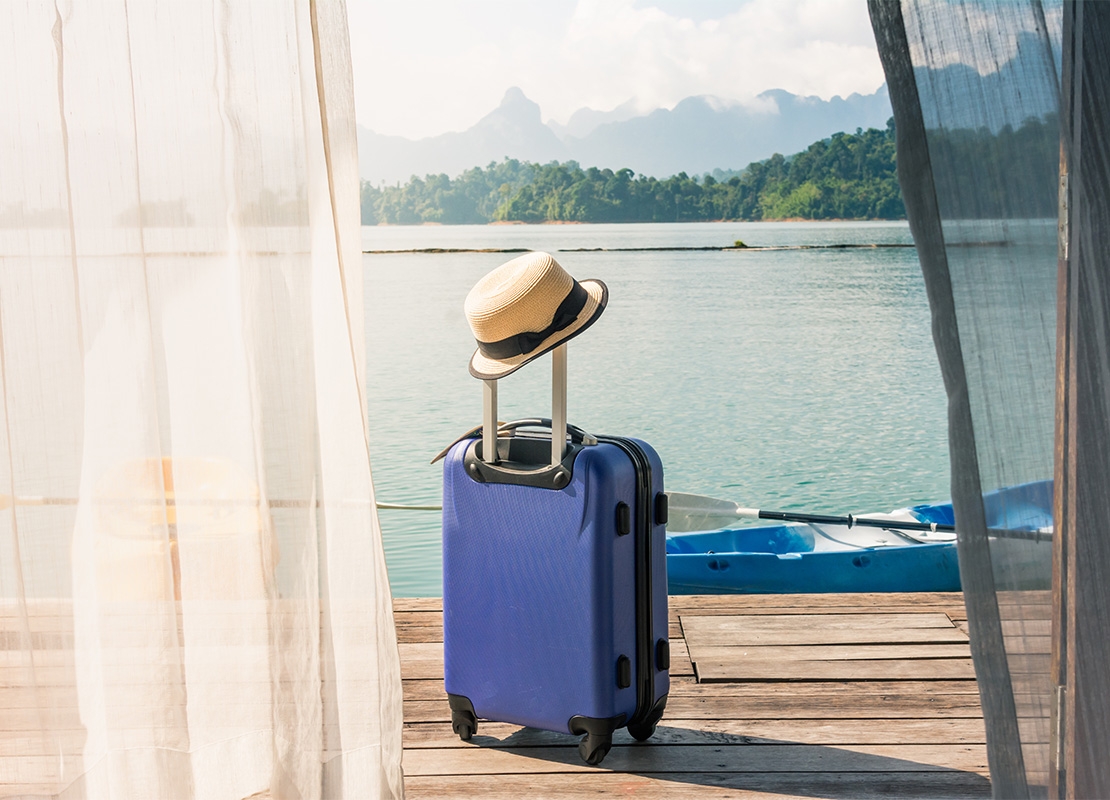 Traveling suitcase on the floor with cap out the room, travel li